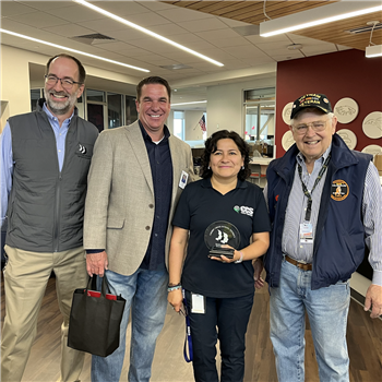 honoree smiling with superintendent and principal 